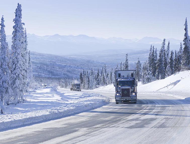 Image of semi-truck driving in the winter