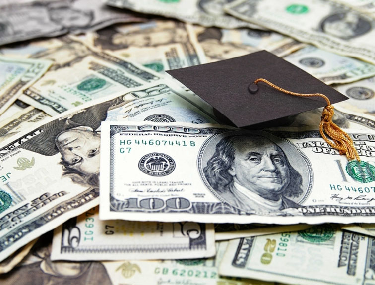 Image of cash with a graduation cap laying on top