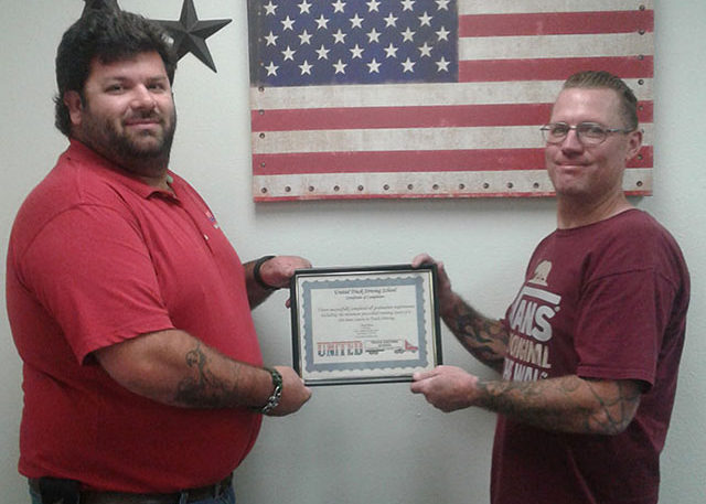 Image of Ryan Capreece and another man holding CDL certificate