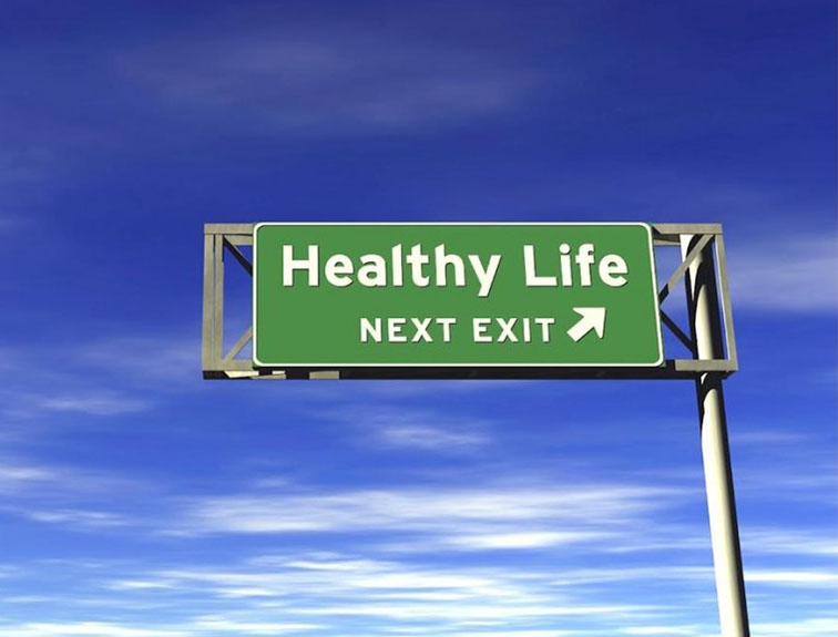 Image of a road sign that reads "heathy life next exit" in front of a blue sky