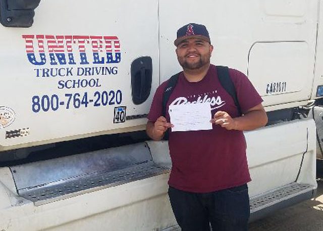 Image of Christopher Arce with certificate in front of United truck