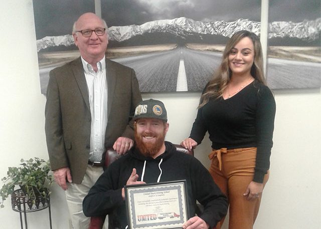 Image of Cameron F with certificate and two other people