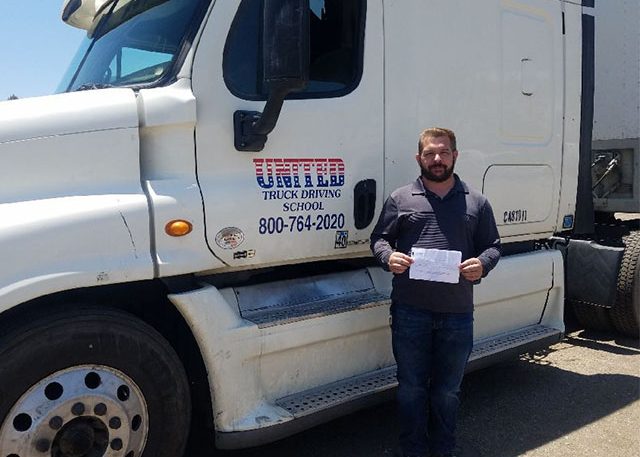 Image of Craig H with certificate in front of United truck