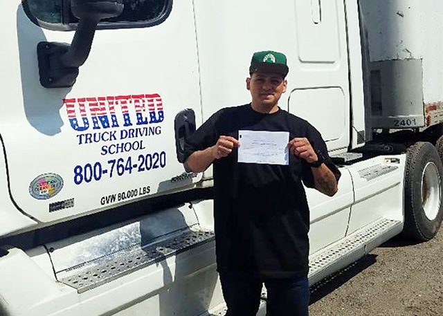 Image of Erik M with certificate in front of United truck