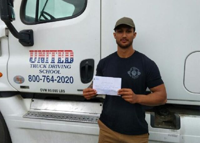 Image of Joseph J with certificate in front of United truck