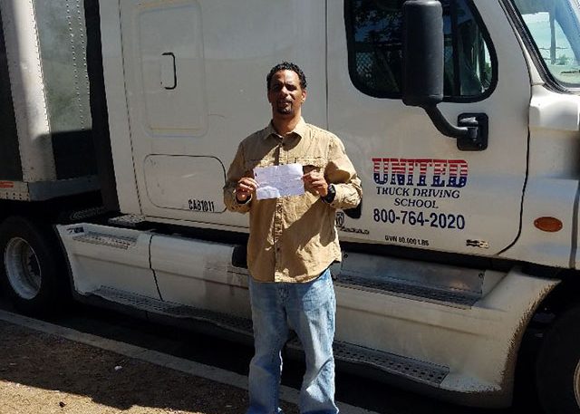 Image of Londale H with certificate in front of United truck