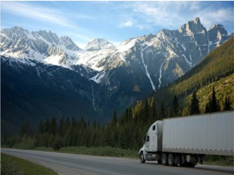 Image of white truck in front of mountains