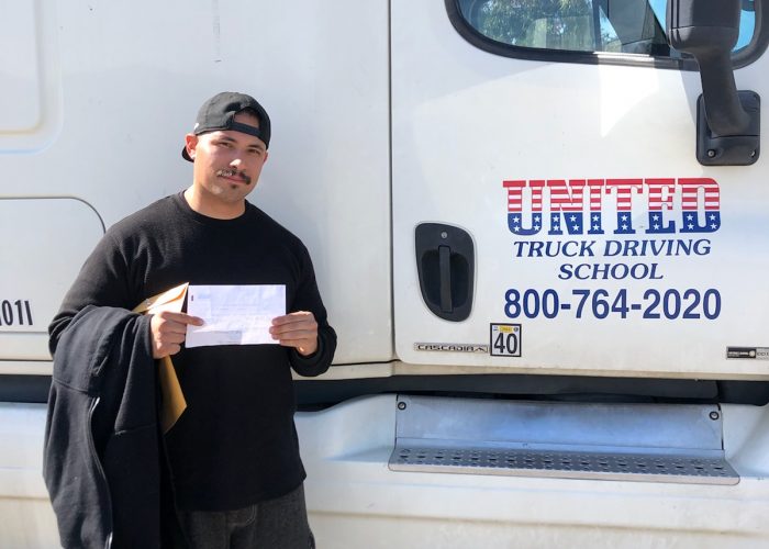 Image of Daniel Ramirez with certificate in front of United Truck
