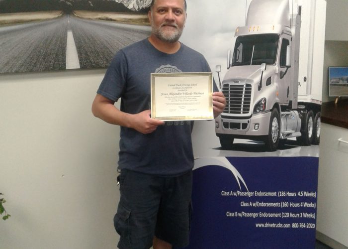 Image of Jesus Velarde Pacheco standing with his certificate