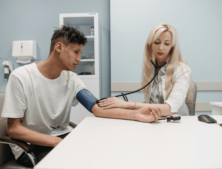 image of a man having his pulse checked during an exam