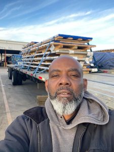 photo of Lamont Fields in front of a Melton Flatbed Semi Truck