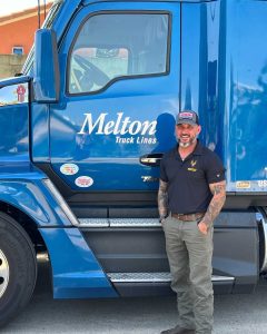 Photo of CDL graduate Shaun Valdavia in front of a Melton Truck Lines Semi Truck