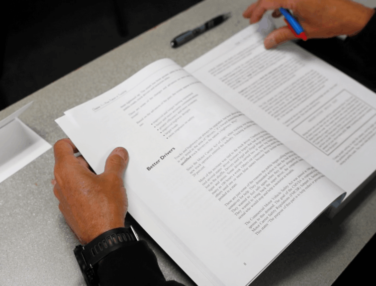 Person holding paperwork and pen