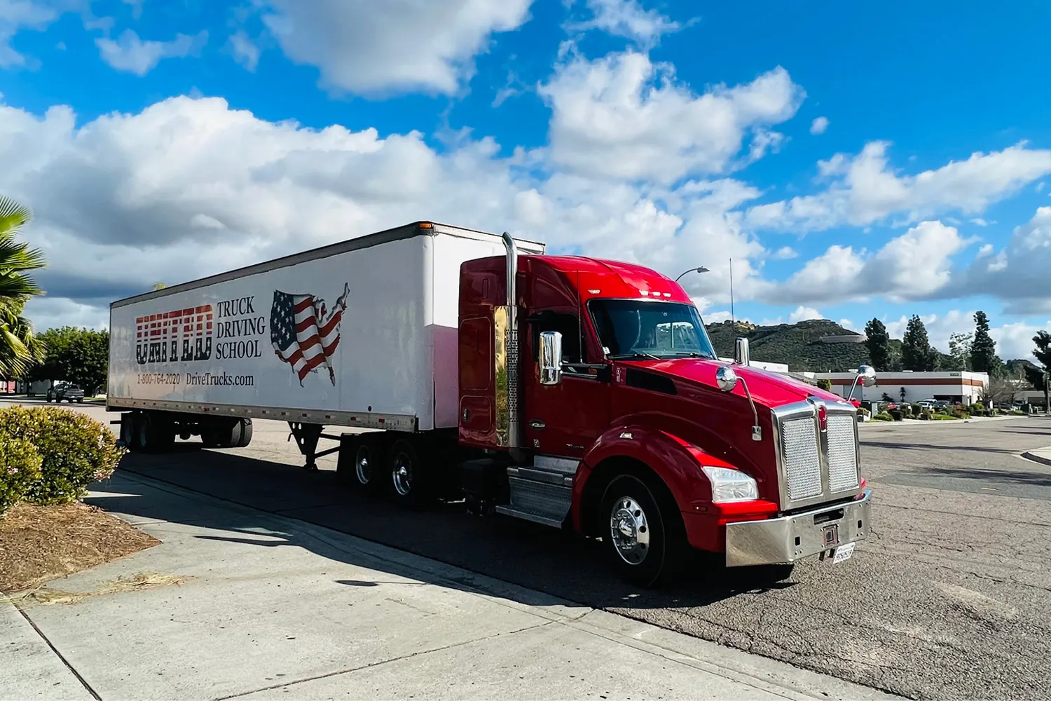 Red United truck parked in parking lot in front of a blue sky